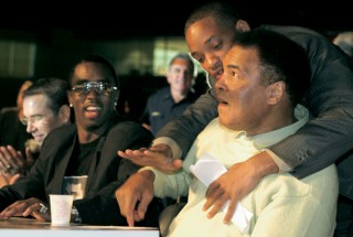 Will Smith holding Ali back in a mock tirade, watched by P Diddy.