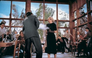 Still from 'North by Northwest' (1959). Eve Kendall (Eva Marie Saint) shoots Roger Thornhill (Cary Grant) in front of the implacable gaze of the presidents at Mount Rushmore.