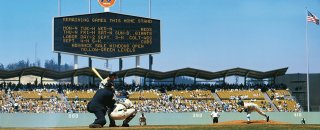 Koufax in action, Los Angeles Dodgers vs. Milwaukee Braves, August 25, 1963. On another gorgeous day in Southern California, with ocean waves represented by the pavilion roof, catcher Doug Camilli, umpire Ed Sudol, and a Braves batter enjoy a close-up view of Sandy Koufax in action. The Dodgers ace came within one out of a shutout, allowing a ninth-inning run as the Dodgers won 2-1. Photo (c) Neil Leifer