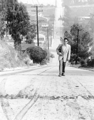 <em>Art Pepper climbing the hill on Fargo Street in Los Angeles near his home symbolizing his up-hill struggle with his drug addiction and his career. Photo: William Claxton</em>