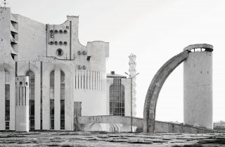 <font size="1">The Fyodor Dostoevsky Theater of Dramatic Art, a surreal masterpiece by Vladimir Somov, designed to echo the primitive religious architecture of Veliky Novgorod, is surrounded by a spacious esplanade made up of modular motifs that repeat those of the construction itself. The column, which balanced the ensemble, was razed in 2008 because of its use by would-be suicides. Veliky Novgorod, Russian Federation, 1987.<br /> Photo &copy; Fr&eacute;deric Chaubin</font>